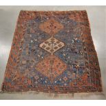 A middle eastern wool on wool rug, possible Afghan, blue and red ground with geometric design,