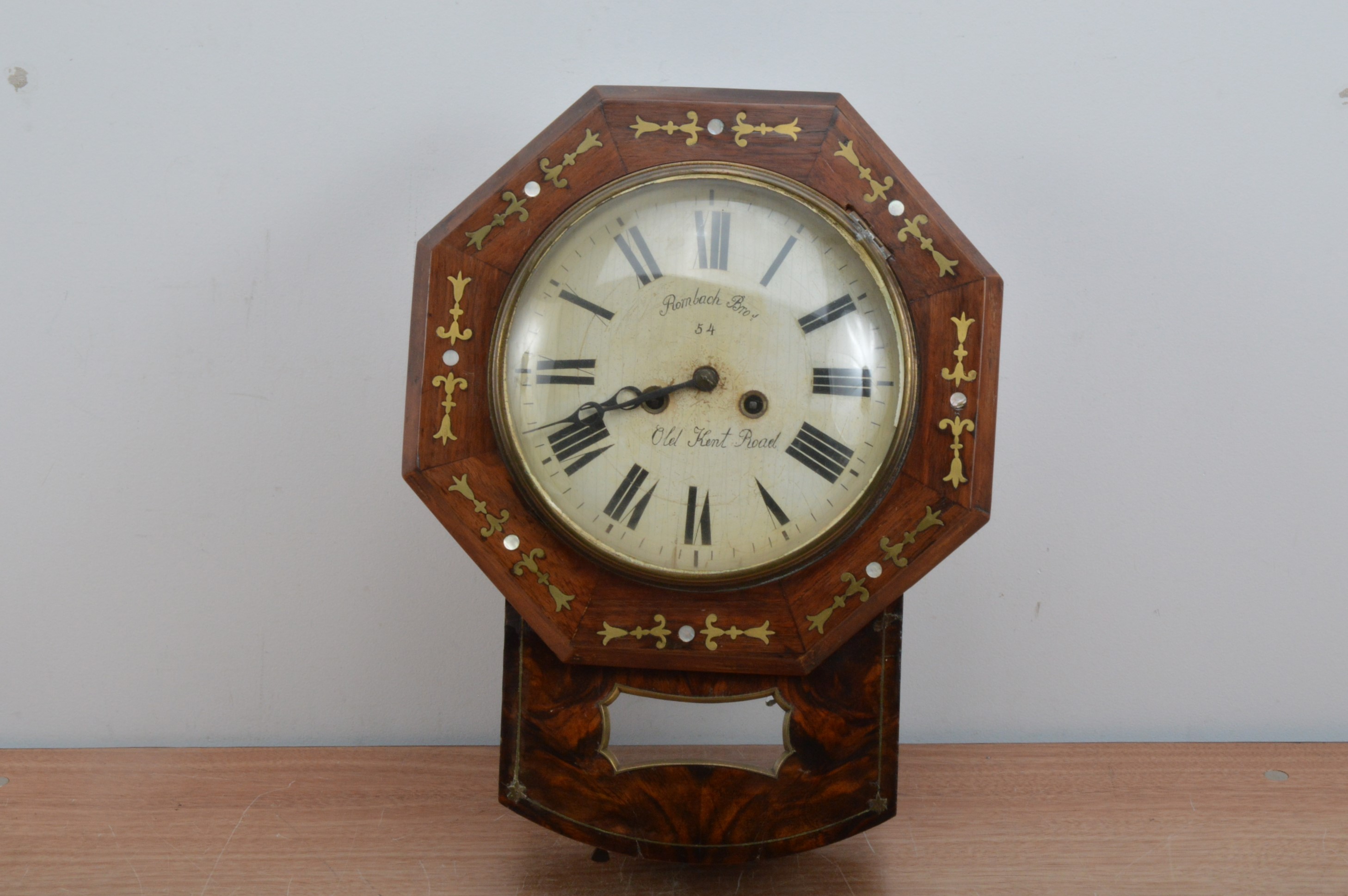 A 19th century wall clock, the dial with Roman numerals, retailed by Rombach Bro's of Old Kent Road,