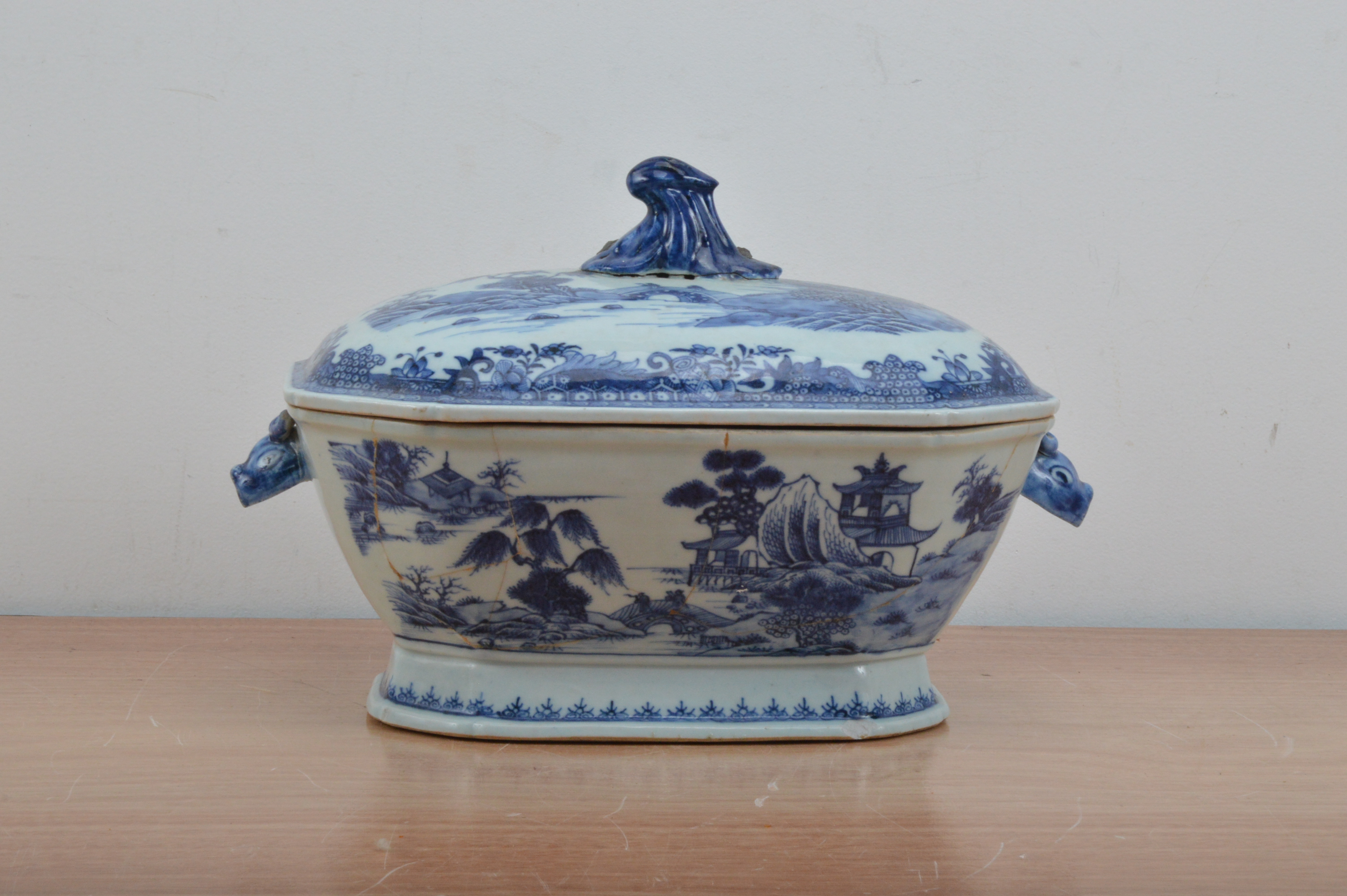 A Chinese ceramic twin handled tureen and cover, transferware design, the body cracked and repaired,