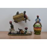 A majolica ceramic blackamoor covered vessel, the cover with a figurine of a black boy, 28cm high,