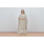 A 19th century Staffordshire ceramic figure of Queen Victoria, commemorating her Golden Jubilee,