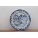 A large Chinese blue and white ceramic charger, probably 19th century, cracked and staple