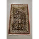 A silk and wool prayer mat, fringes, 140cm x 61cm