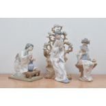 Three Lladro ceramic Japanese lady figurines, the largest a lady with a mirror leaning on a tree (