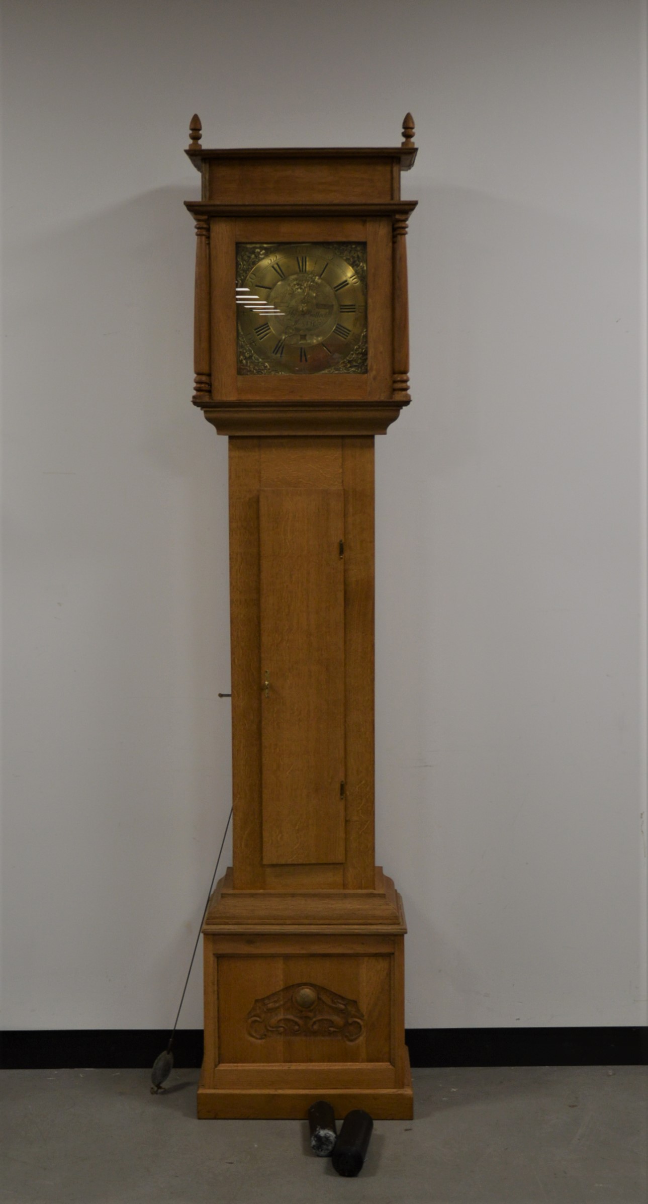 A modern oak longcase clock, brass dial with Roman numerals, with date dial, makers name Tho.