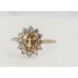 A yellow and colourless zircon cluster ring, oval shape central claw set stone surrounded by round