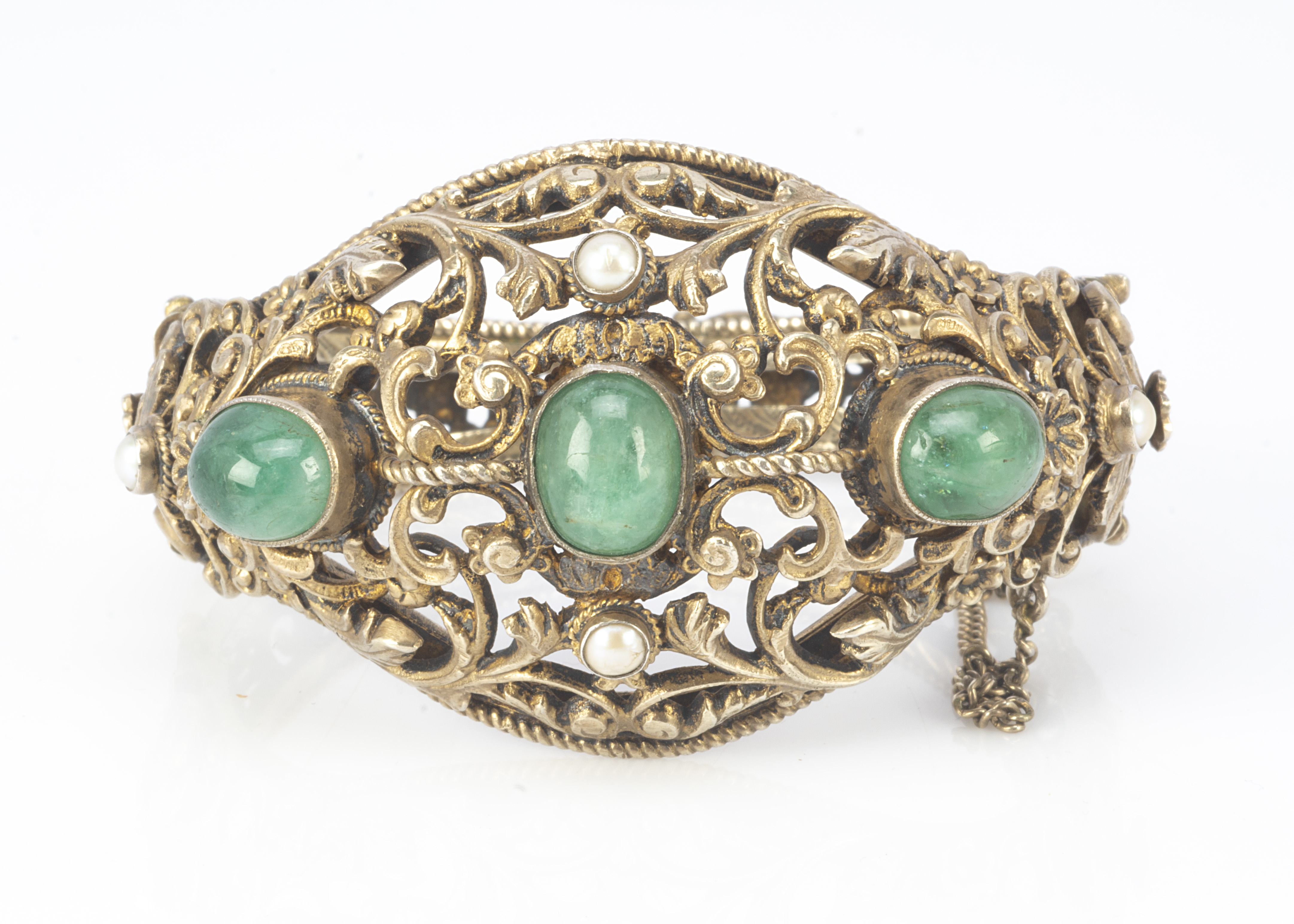 A 19th Century Austro Hungarian silver gilt pearl and green hardstone openwork bangle, with scroll