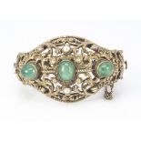 A 19th Century Austro Hungarian silver gilt pearl and green hardstone openwork bangle, with scroll