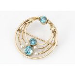 A 14ct gold zircon and cultured pearl openwork brooch, the three blue graduated set zircons within a