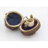 A Victorian or later walnut shell etui case, with brass hinge and frames, contains bone thimble,