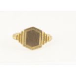 A 9ct gold Art Deco child's signet ring, the hexagonal tablet top with stepped shoulders, ring