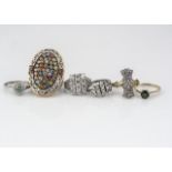 A collection of gem set silver rings, including an Art Deco style fan with silver gilt shank, a teal