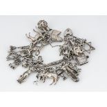 A silver charm bracelet, with multiple charms, including horses, keys, elephants, etc, 110g