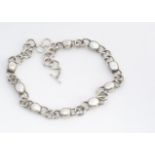 An Arts and Crafts style silver and mother of pearl necklace, the curb links alternately set with