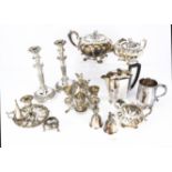 A collection of silver plated items, including an egg waiter, chamberstick, pair of candlesticks,