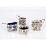 Four early 20th century silver cruet items, including a pierced salt and mustard, a mustard and