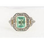A contemporary 18ct gold Lorique emerald and diamond dress ring, the step cut emerald in four claw