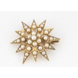 A 15ct gold seed pearl star brooch or pendant, encrusted with seed pearls to pierced setting, marked