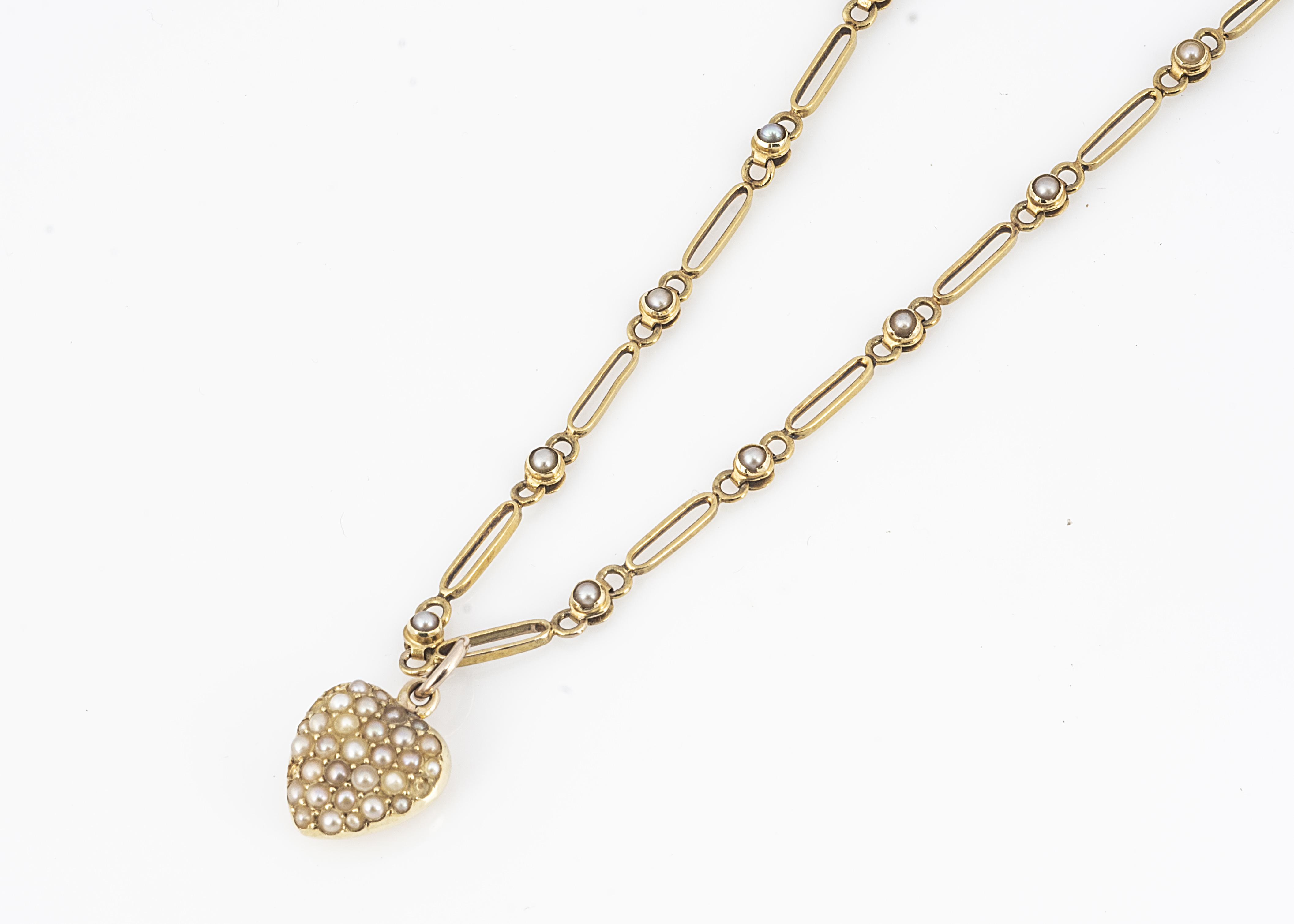 A 15ct gold seed pearl necklace, and heart shape drop, the oval links alternately set with seed