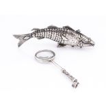 A vintage articulated fish, 10.5cm long with hinged head and compartment, together with a small