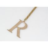 A 9ct gold initial R pendant, on a 9ct gold chain, 28cm together, 5.9g