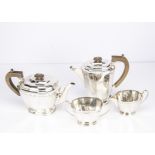 An Art Deco period silver four piece tea set by EV, faced with engraved geometric design, 48.75 ozt,