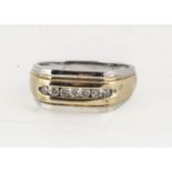 A 9ct gold two colour gentleman's diamond set dress ring, channel set brilliant cuts to tablet