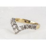 An 18ct gold diamond set wishbone half eternity ring, the brilliant cuts in claw settings,
