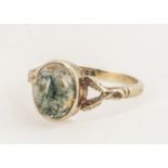 A 9ct gold and moss agate dree ring, oval cabochon in collet setting on double twist shoulders, ring