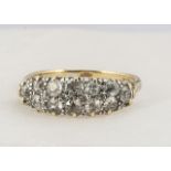 An 18ct gold diamond double band dress ring, the old cuts in claw setting, on a scroll gallery, fine