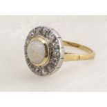 An 18ct gold opal and diamond target ring, the round cabochon cut opal surrounded by old cut