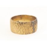 A 9ct gold wedding band, of flattened textured form, ring size L 1/2, 8.8mm, 5.4g