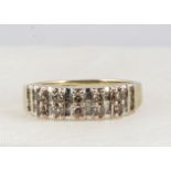 A 9ct gold pink and colourless diamond dress ring, the band set with baguettes and round brilliants,