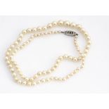A string of cultured pearls, graduated and knotted strung, largest 6.9mm, smallest 3.3mm, 49cm long,