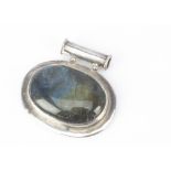 A large silver and labradorite pendant, of oval shape, with cylindrical bale, 5.3cm wide x 5cm deep,