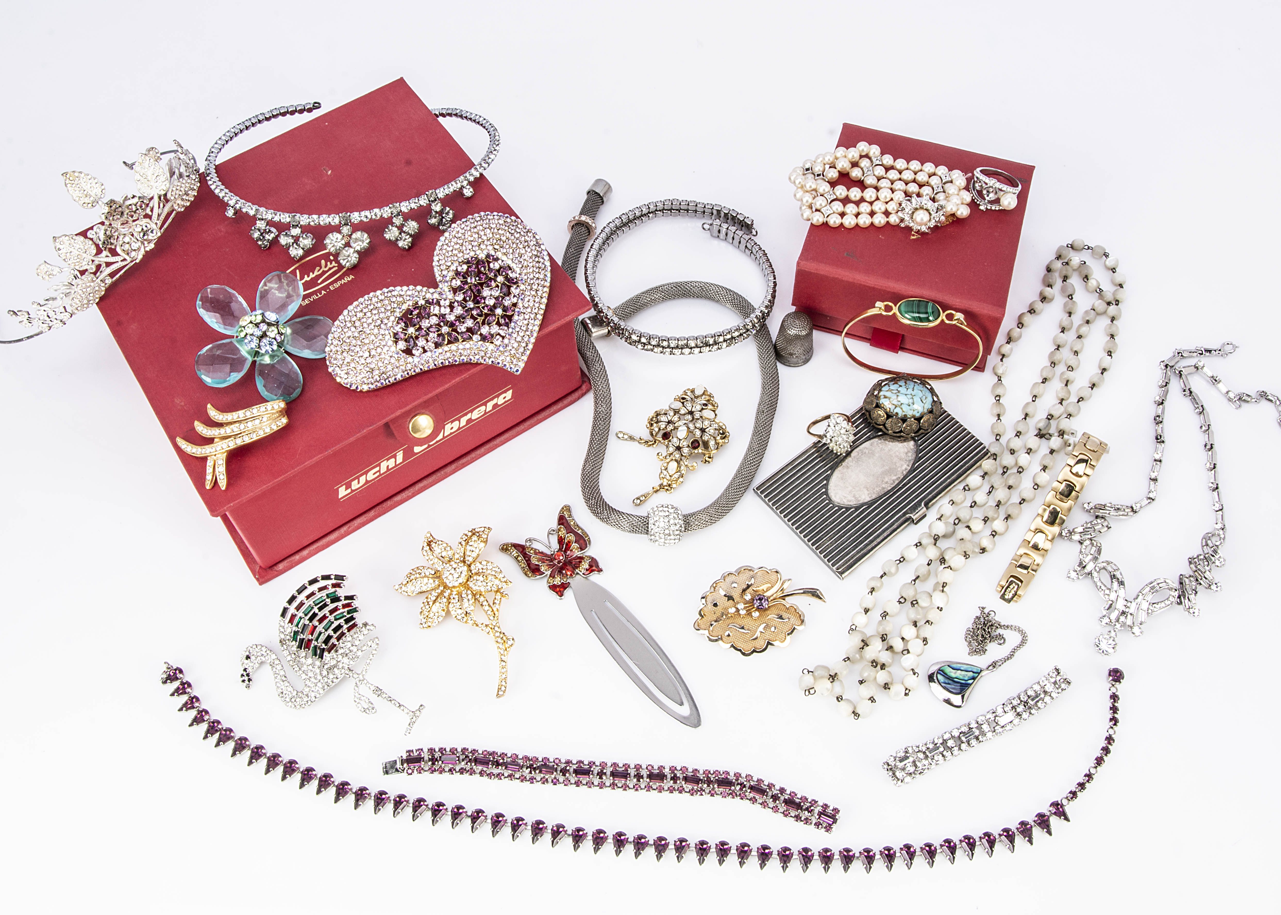A collection of paste jewellery, including a flamingo brooch, two paste tiaras, mother of pearl