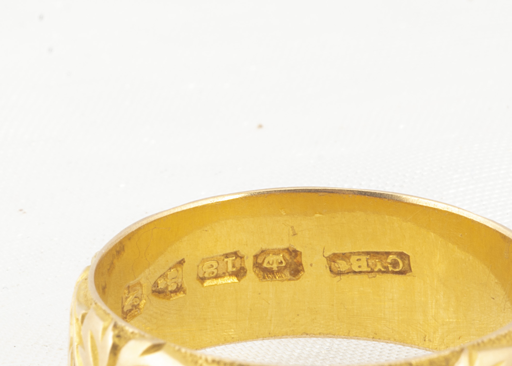 An 18ct gold engraved wedding band, of domed flattened form, with engraved hearts within a wreath of - Image 2 of 2