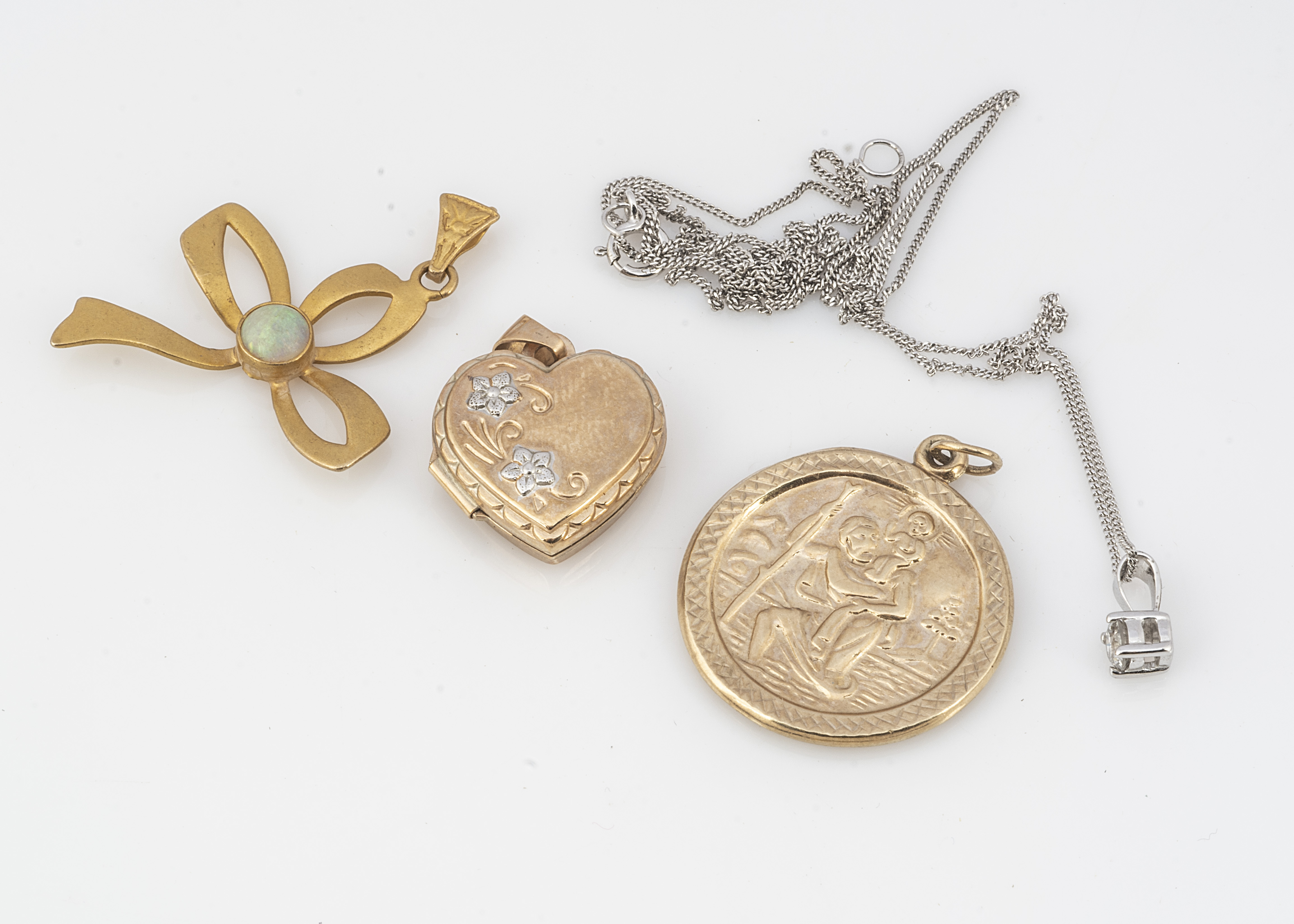 A small quantity of gold pendants, including a St Christopher, a heart shaped locket, small