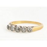 A diamond five stone 18ct gold and platinum set dress ring, the old cut diamonds in millegrain