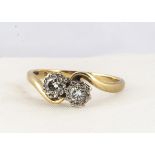 An 18ct gold diamond cross over dress ring, the brilliant cuts in illusion settings, on a hallmarked