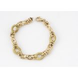 An 18ct gold oval link bracelet, with textured and polished links, 19cm long, 16g