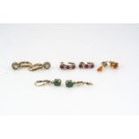 A small collection of 9ct gold gem set earrings, including rubies, diamond, and emerald, 8.8g