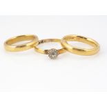 Three 22ct gold wedding bands, one set with a paste stone, ring size Q, a round example, ring size
