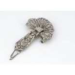 An Art Deco style silver and paste floral brooch, with dropped, pierced festoon, set with paste