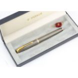 A modern Parker Sonnet silver fountain pen, silver and black enamel with gilt clip, 18ct gold nib,