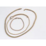 A collection of 9ct gold necklaces, including a fine link chevron example, another cylindrical