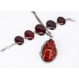 A silver and carnelian bracelet, oval graduated panels in collar settings 21 cm long and an '
