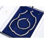 A 9ct and silver necklace and bracelet set, the curved links with spiral and thread design, matching