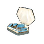 A cased Art Deco silver and enamelled six piece dressing table set by AC, the hexagonal fitted box