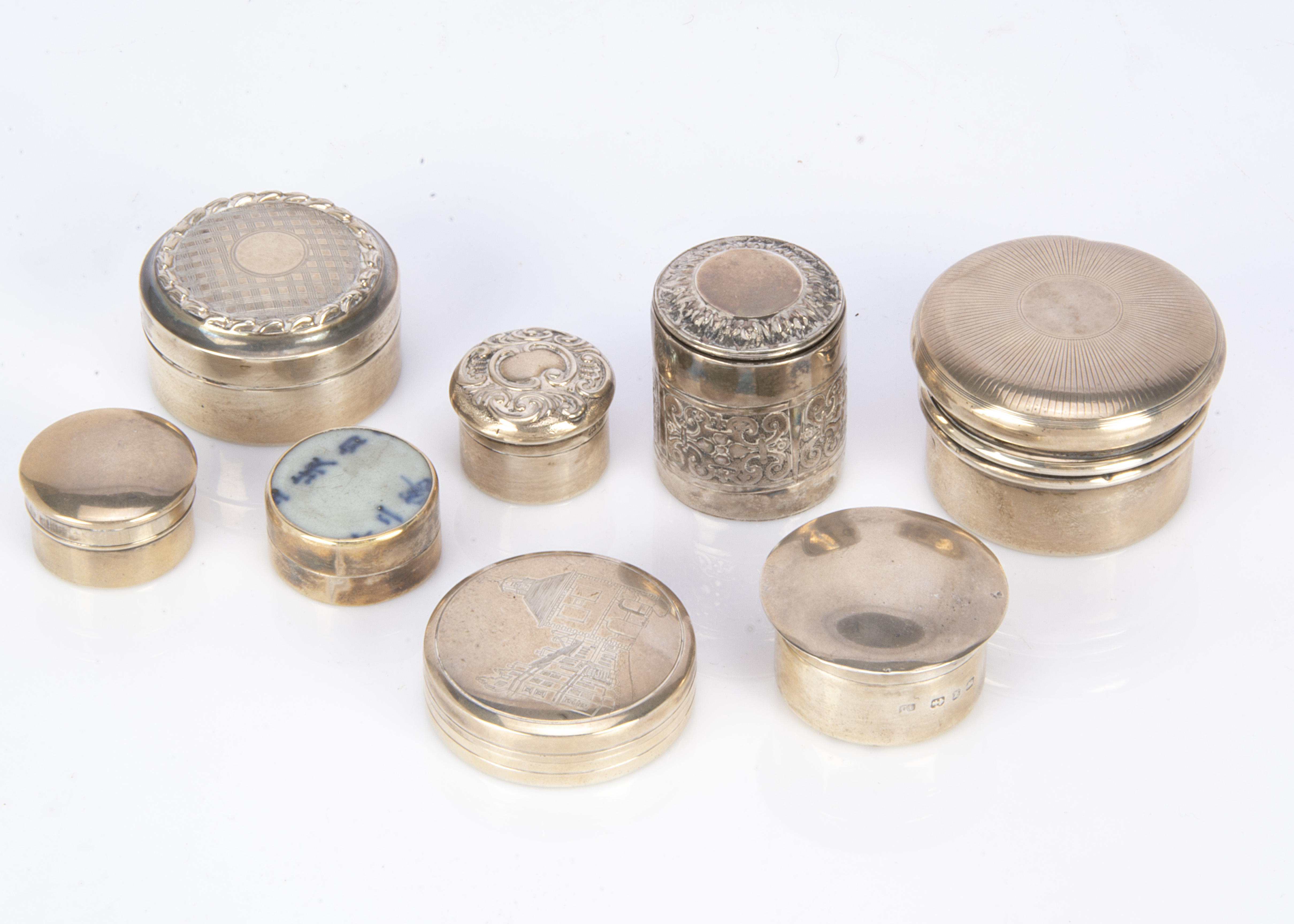 Five silver circular boxes, largest 4.5cm diameter, together with a small metal box with applied